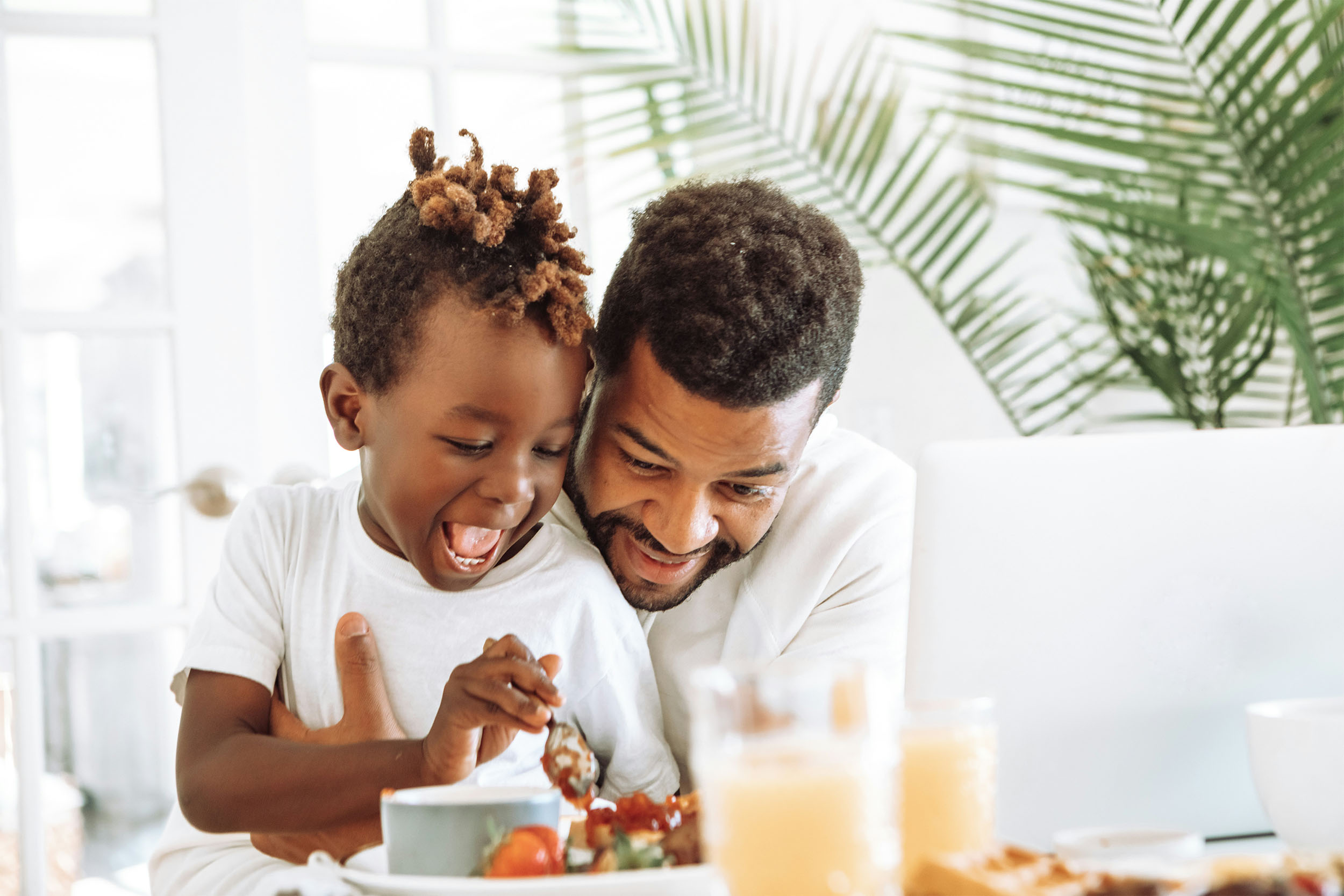 image of man and child at breakfast